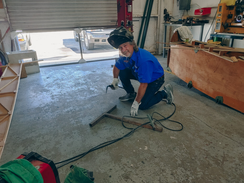 One Man Welding a Sign together One Man Welding a Sign together